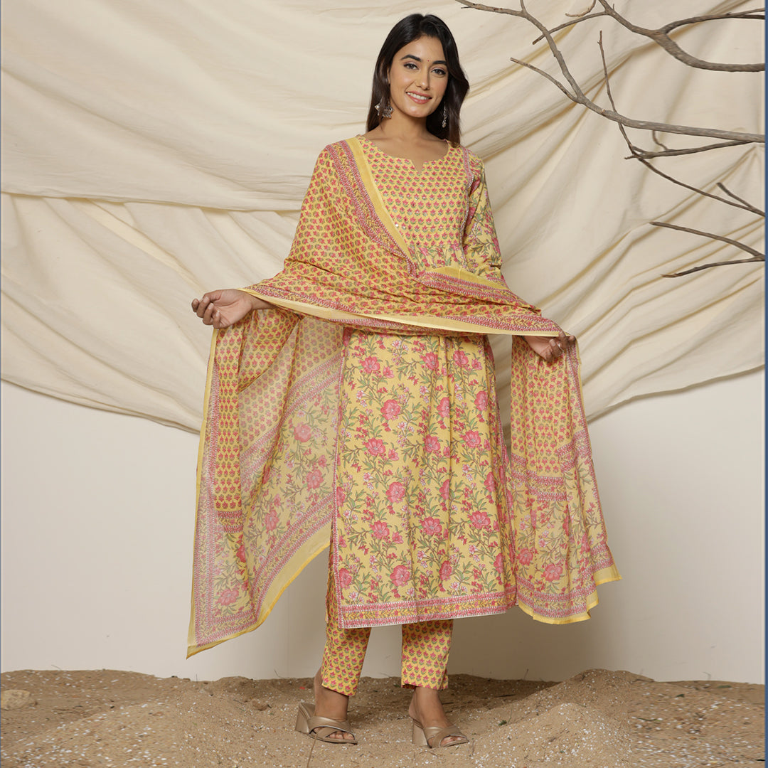 Front view of Yellow Lily Printed Cotton Suit from Cottons Daily, featuring a floral printed Nyra cut kurta with 3/4th sleeves, paired with matching straight-fit pants and a floral printed dupatta.