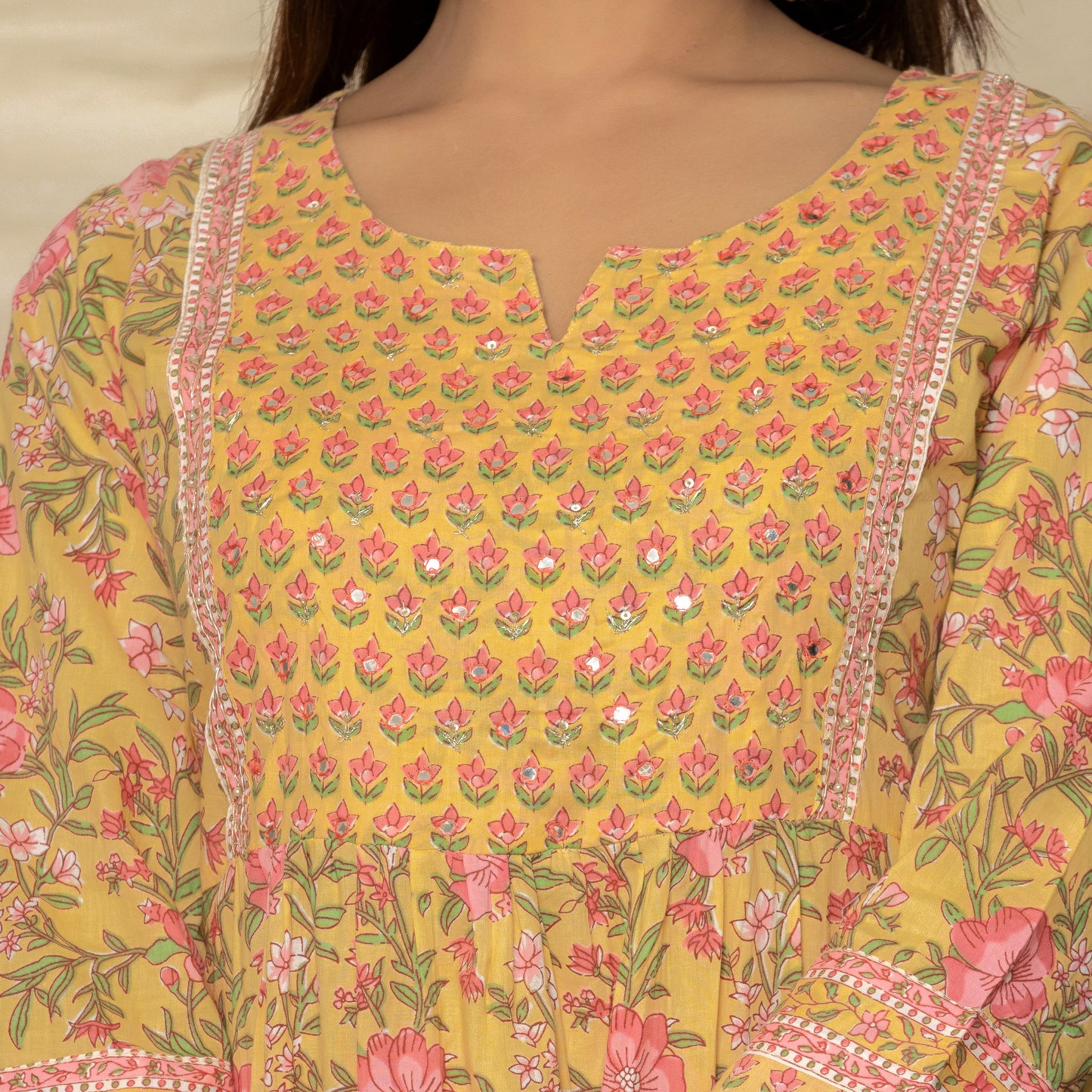 Close-up of the Round V Cut Neck design on the Yellow Lily Printed Cotton Suit's floral printed Nyra cut cotton kurta.