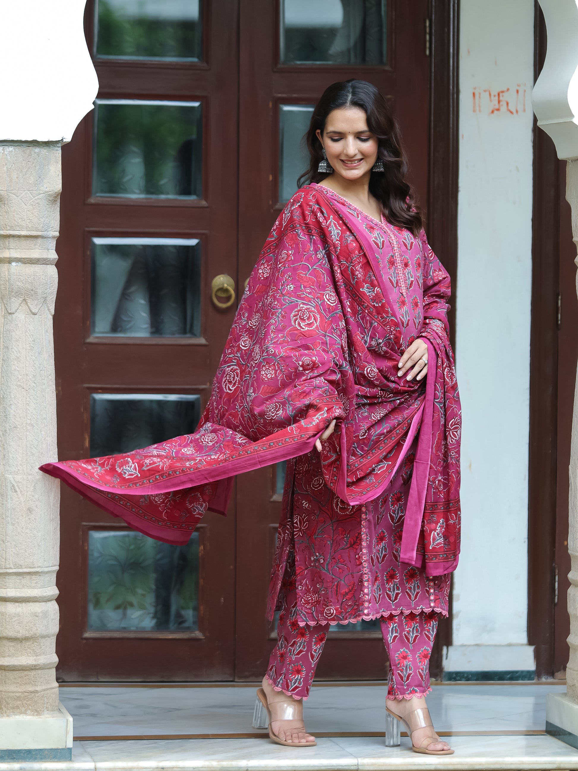 Model showcasing the complete Dark Fuschia Mirror Work Cotton Suit by Cottons Daily, including the straight-cut top with mirror and lace work, floral printed straight-fit pants, and a coordinating floral printed dupatta, exemplifying elegance and comfort.