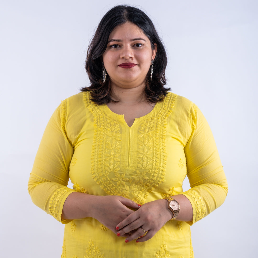 Front view of a fluorescent yellow hand-chikankari cotton co-ord set from Cottons Daily, featuring a round neck with a slight V cut and intricate handcrafted chikankari embroidery on the pure mulmul cotton fabric.