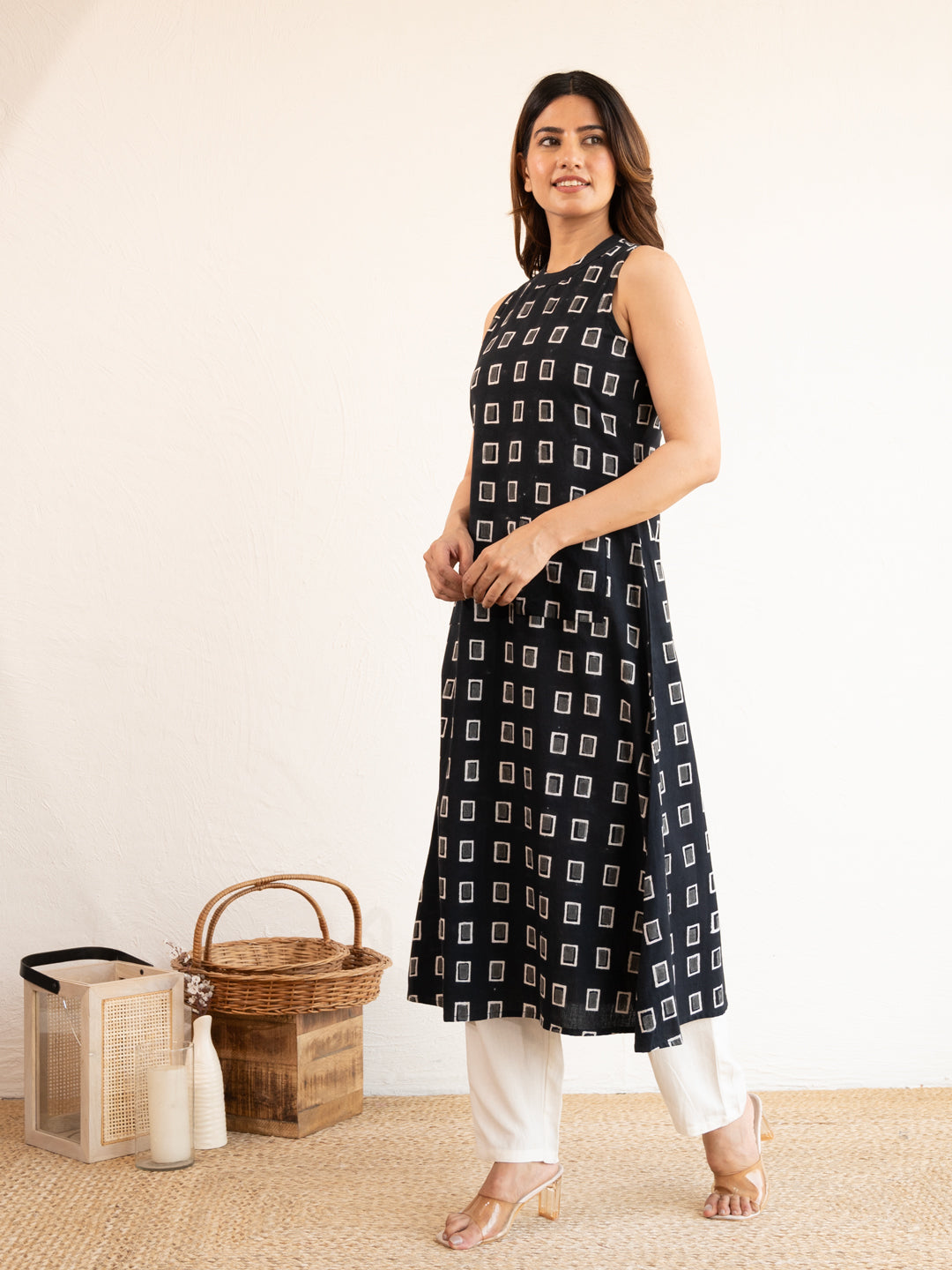Side view of the Everyday Black A-line Cotton Kurta, demonstrating the relaxed drape and comfortable A-line fit of the black cotton fabric.
