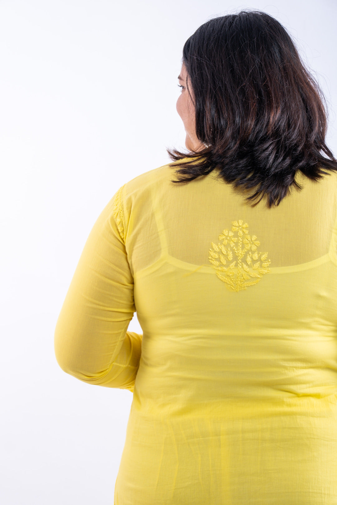 Back view of the fluorescent yellow hand-chikankari cotton co-ord set, displaying the uniformity and elegance of the chikankari embroidery across the ensemble.