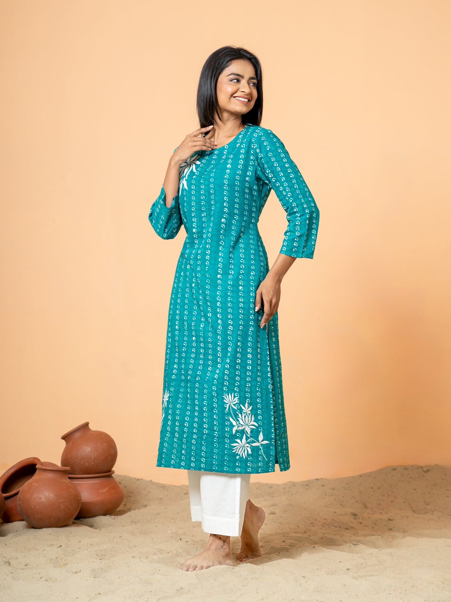 Side view of the Sea Green Pearl Work Kurta, showing the comfortable fit and graceful drape of the sea green cotton material.