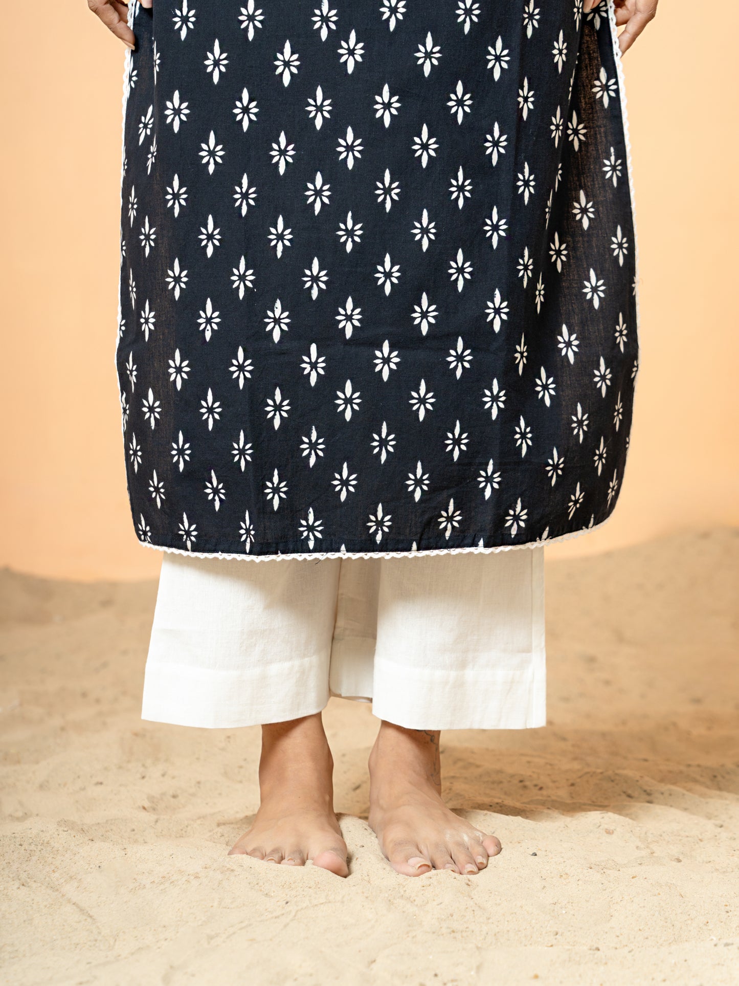 Image focusing on the soft, breathable pure cotton fabric texture and the drape of the Black Sequence Work Rangoli Kurta.