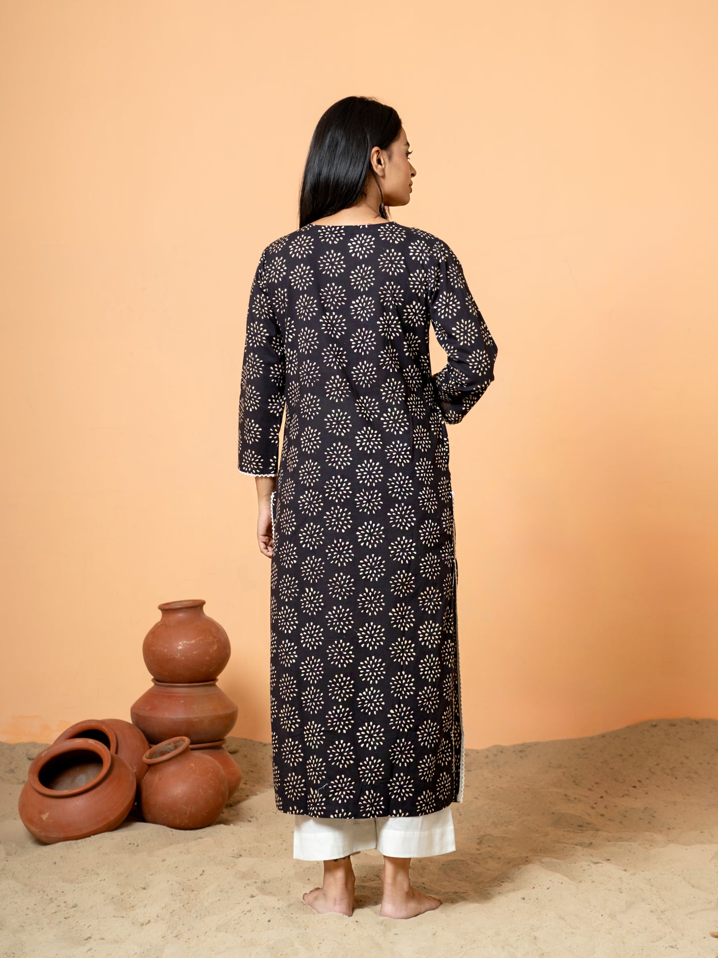 Back view of the versatile Black Embroidered Rangoli Print Cotton Kurta for women.