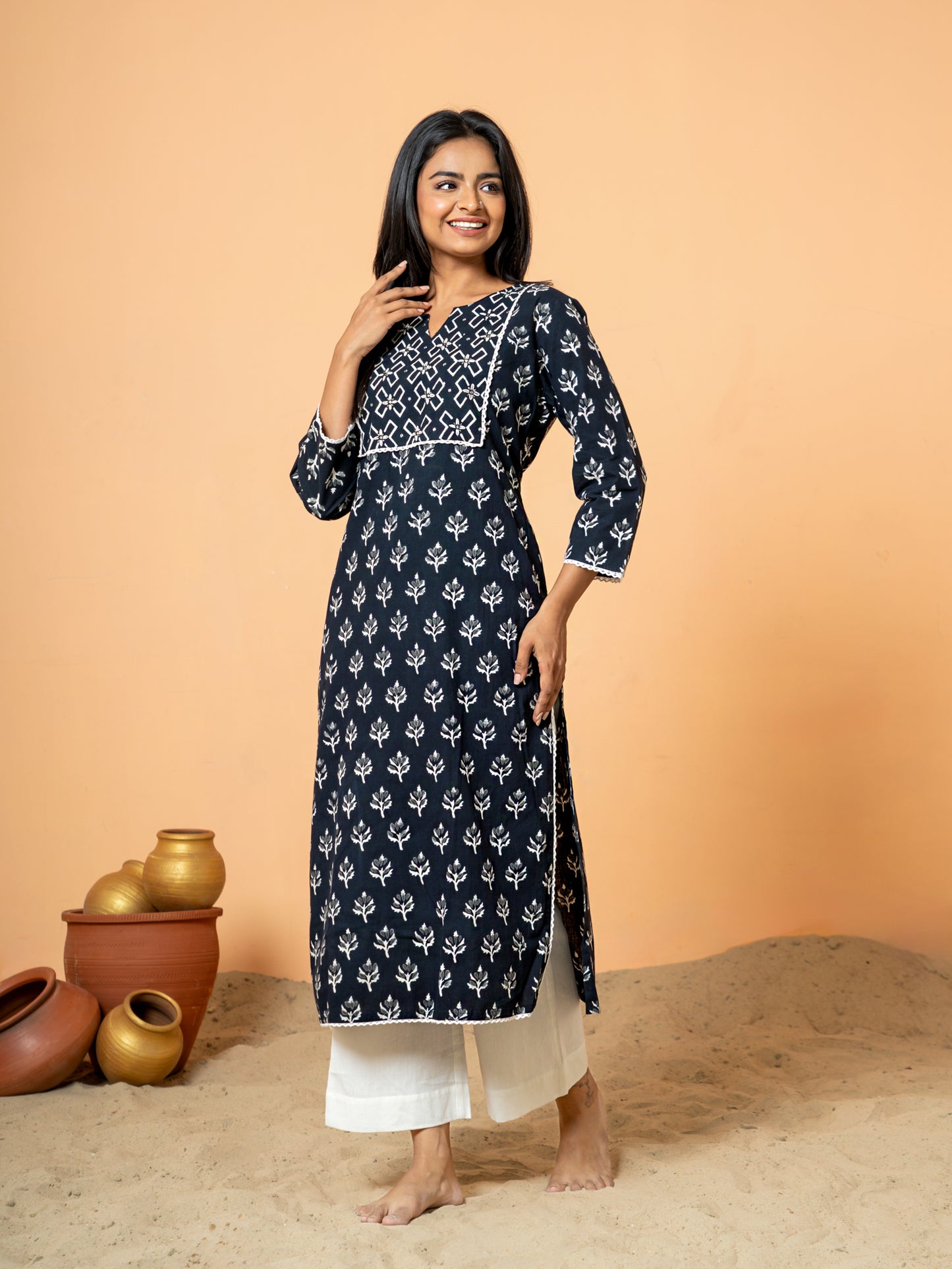 View showing the comfortable regular fit and 3/4th sleeves of the Black Leaf Print Lace Work Cotton Kurta.