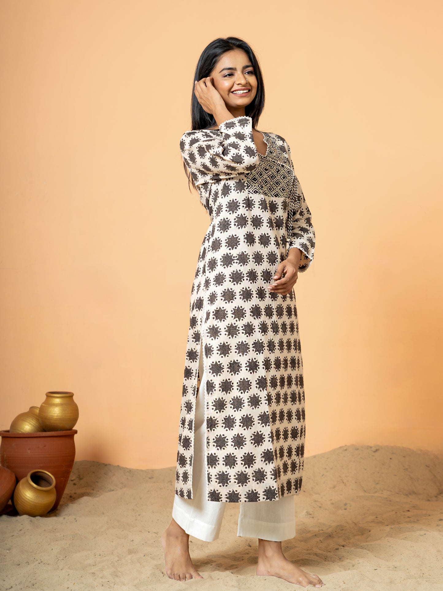 Side view highlighting the intricate embroidery over the colorful rangoli print on the Cream Cotton Kurta, showing the craftsmanship.