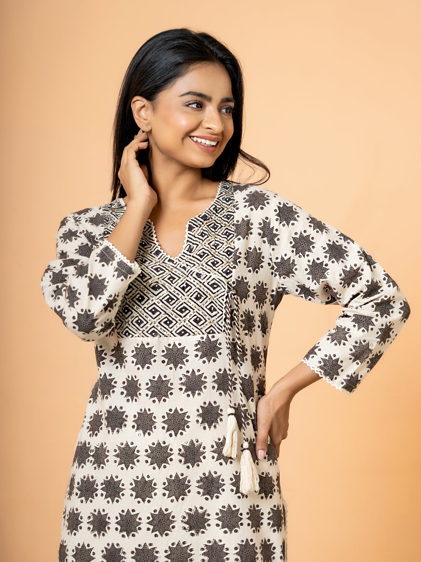 Detail of the sleeve of the Cream Cotton Kurta, showing how the embroidered rangoli print design appears on the sleeves.