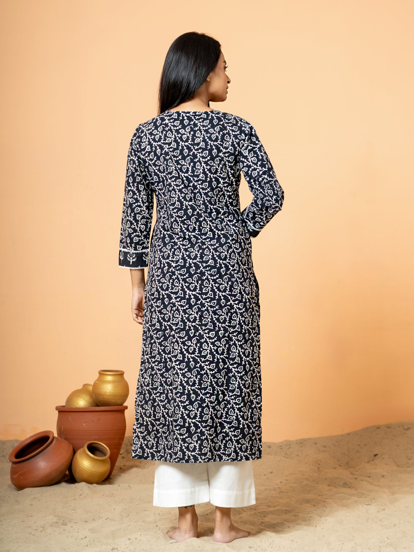 Back view showing the intricate Sanganeri print and zari work at the hem or side slit of the sophisticated Black Cotton Kurta.