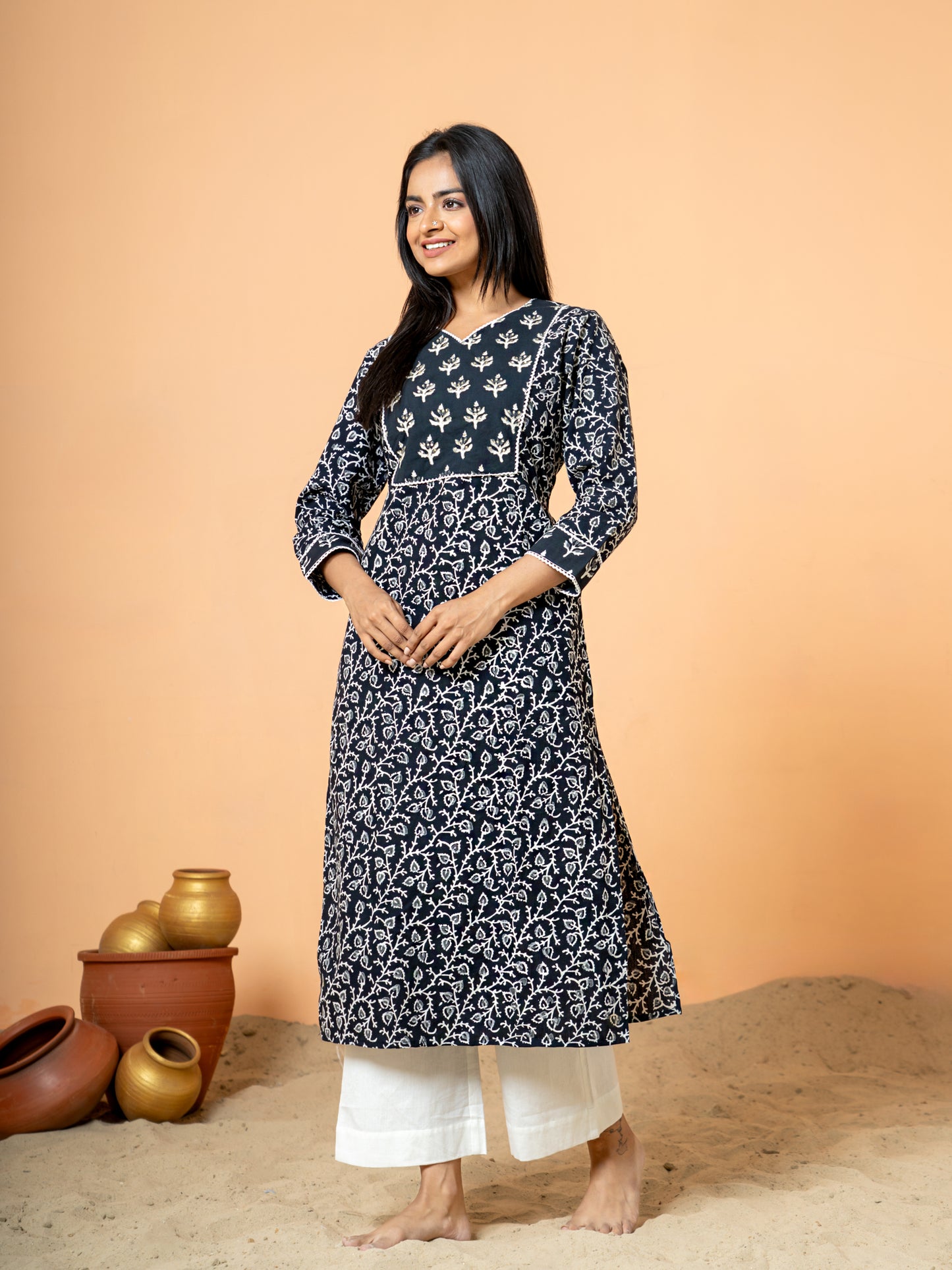 Image showing the comfortable regular fit and 3/4th sleeves of the versatile Black Sanganeri Print Zari Work Cotton Kurta.