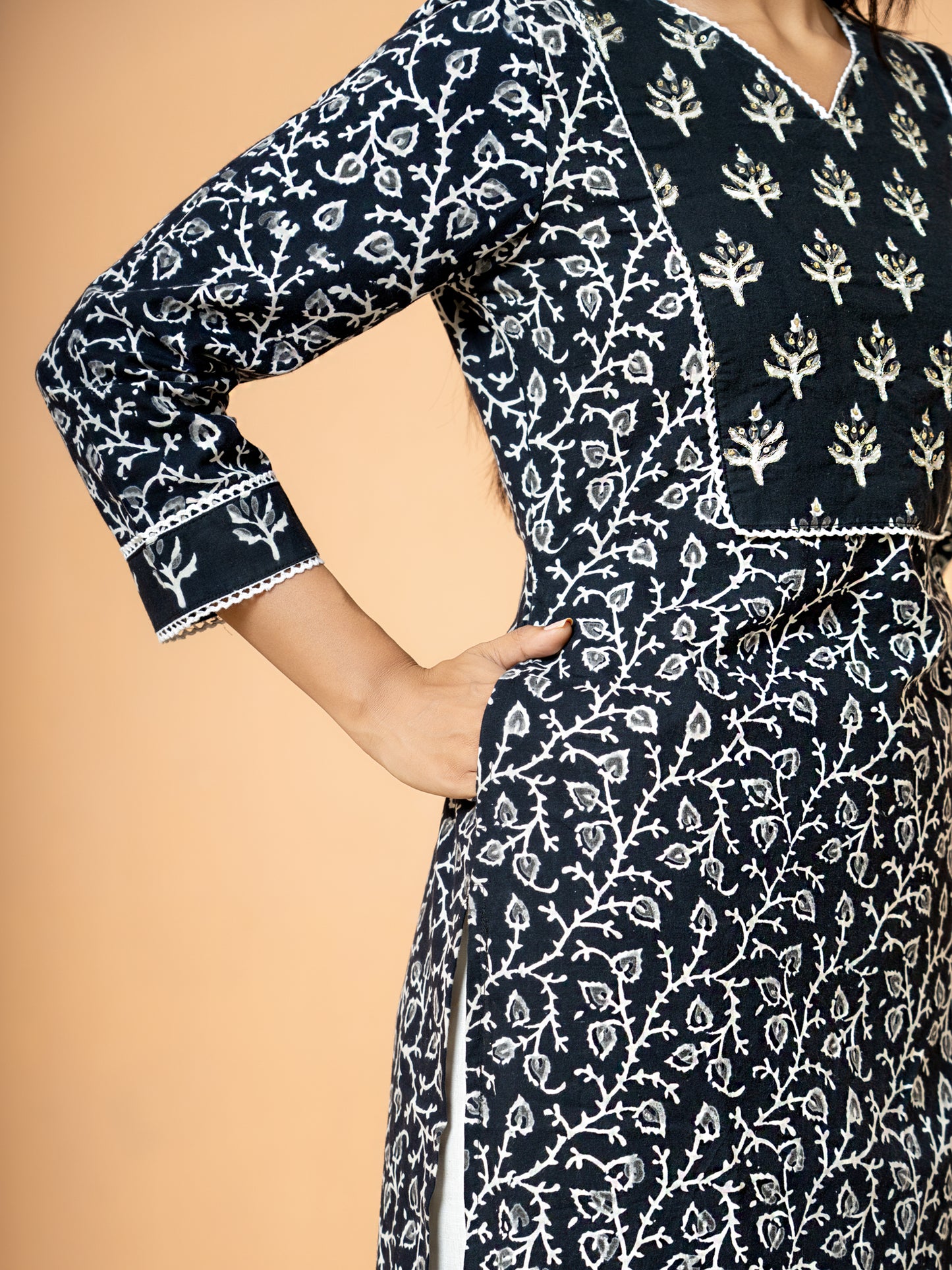 Image focusing on the soft pure cotton fabric texture and the convenient side pocket feature of the Black Sanganeri Print Zari Work Cotton Kurta.