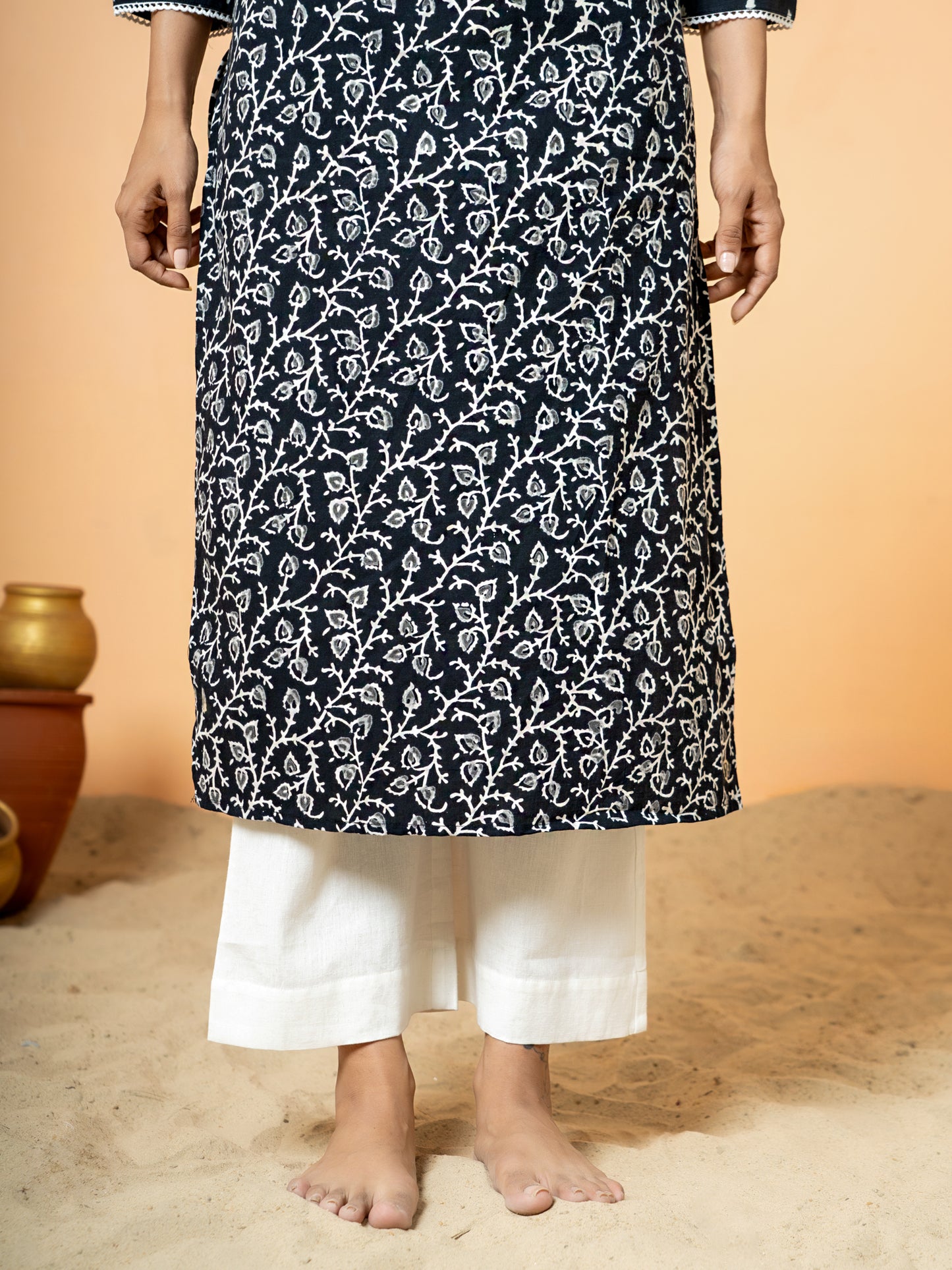 Close-up detail highlighting the traditional Sanganeri print and sparkling zari and sequence work on the fabric of the Black Cotton Kurta.