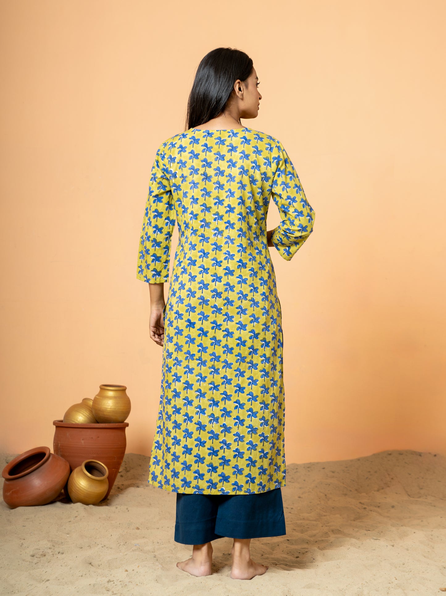 Back view showing the intricate Nayantara prints and Katha work near the hem or side slit of the sophisticated Green Cotton Kurta.