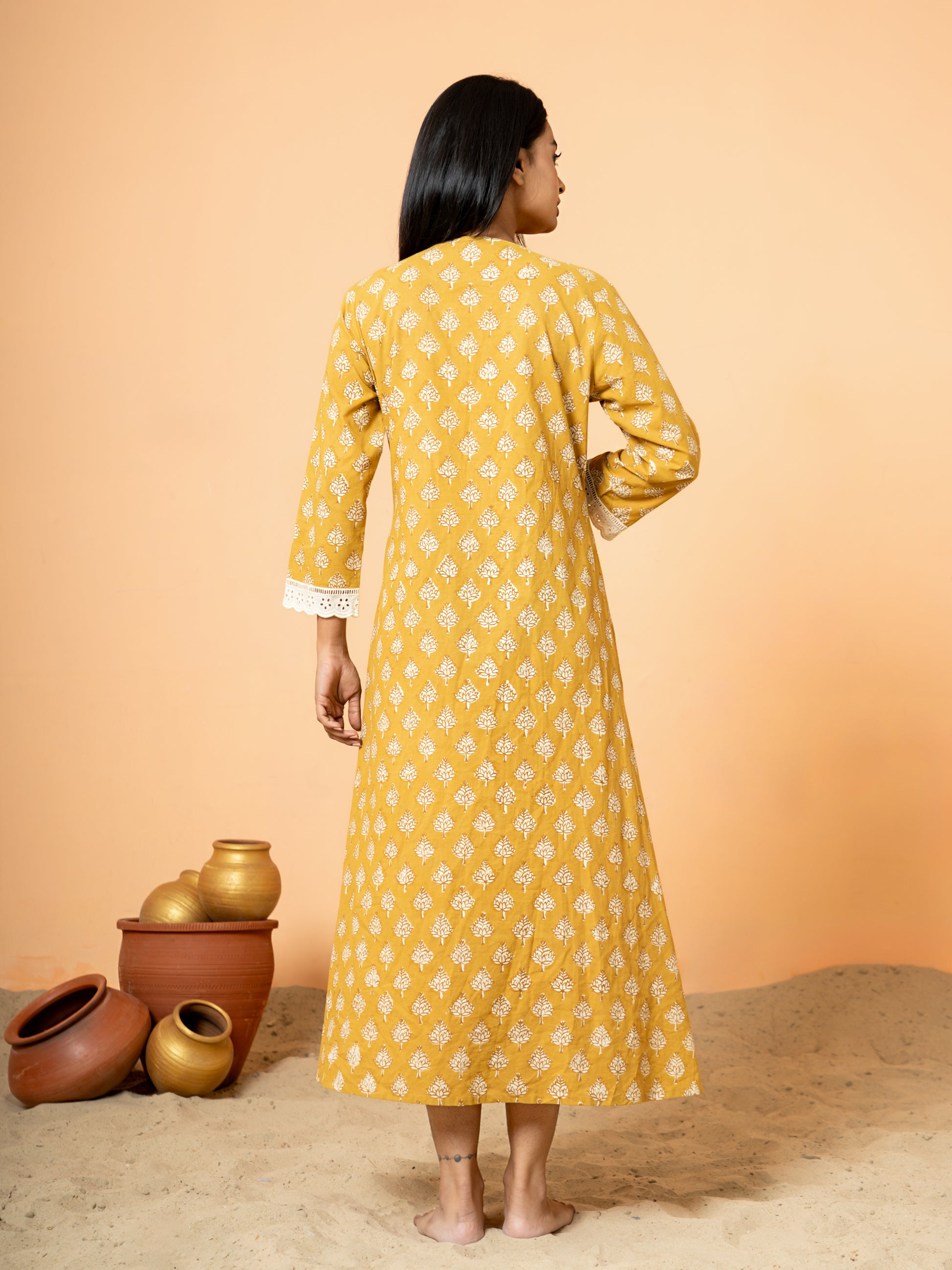 Back view of the Mustard Lace Work Cotton Kurta, showing the plain mustard yellow cotton fabric texture and the overall drape.