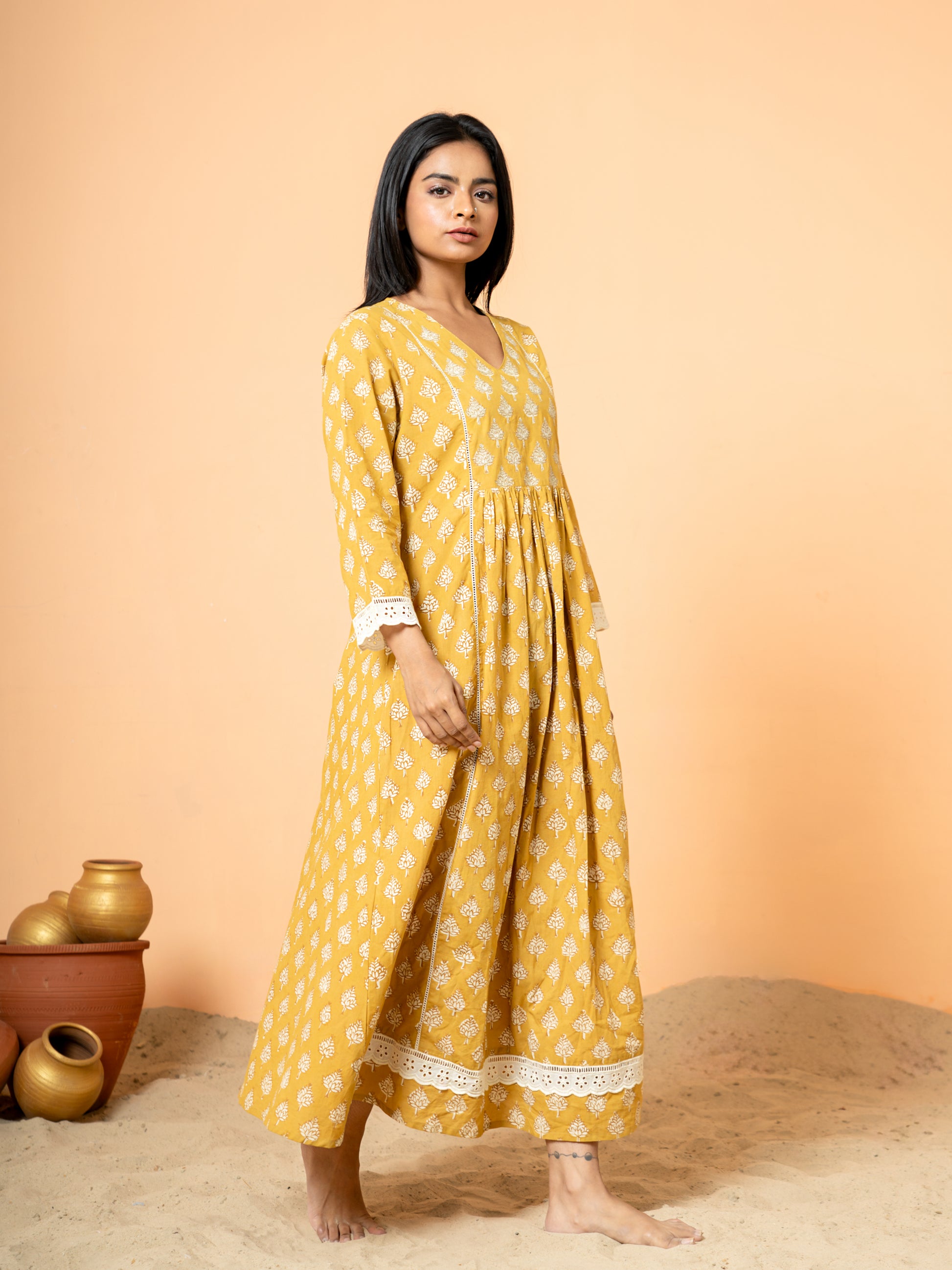 Side profile image showcasing the comfortable fit and structure of the Mustard Lace Work Cotton Kurta in a vibrant mustard yellow shade.