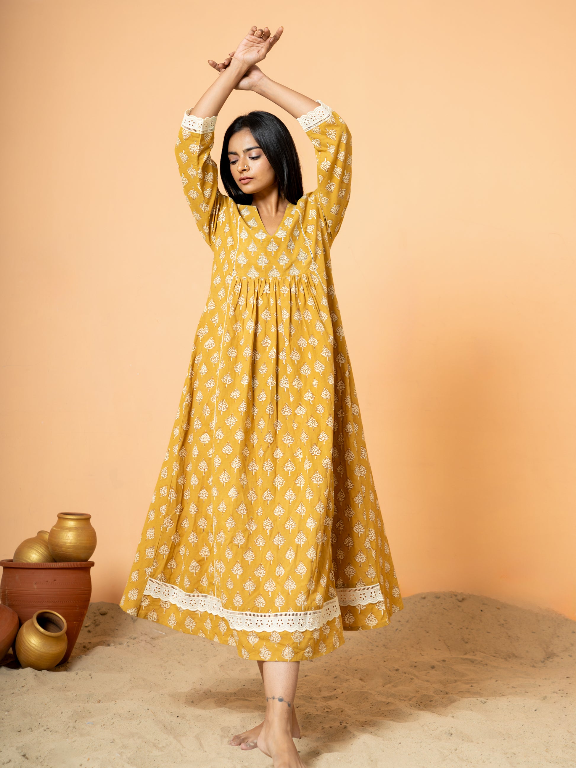 View of the sleeve cuff on the mustard cotton kurta, clearly showing the delicate white lace trim detail.