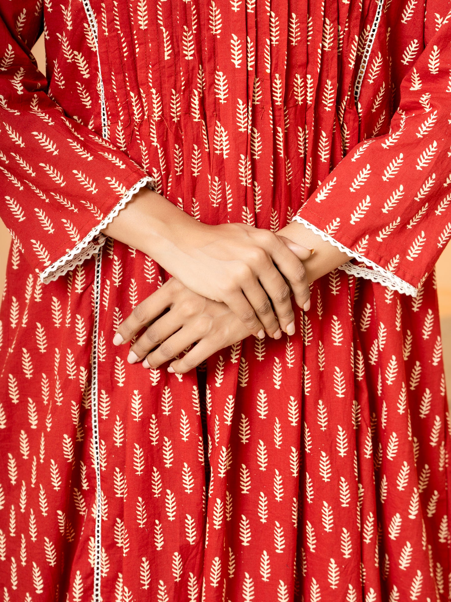 Close-up detail highlighting the intricate palm leaf prints and the texture of the soft, breathable pure cotton fabric of the Red Printed Cotton Kurta.