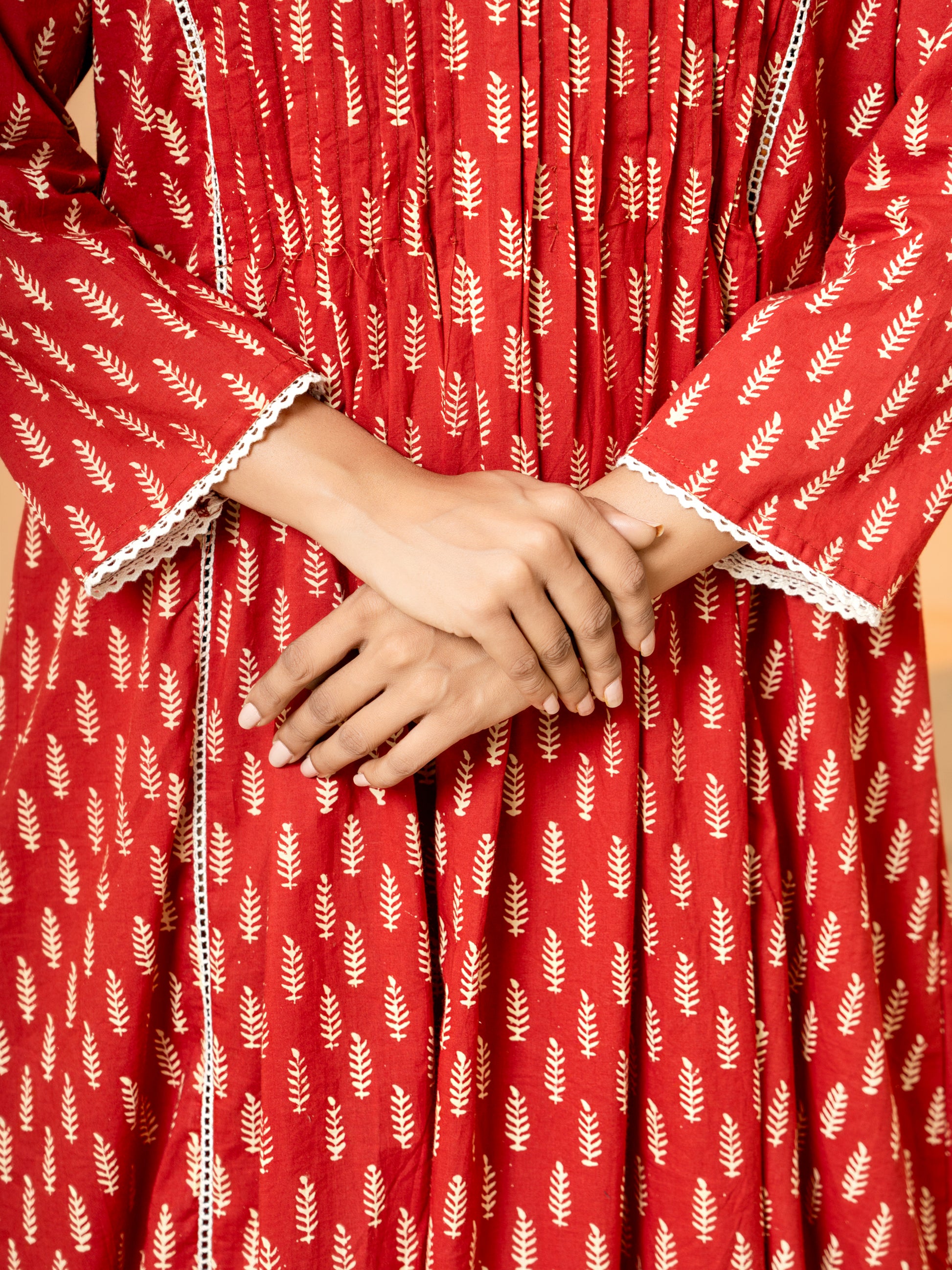 Close-up detail highlighting the intricate palm leaf prints and the texture of the soft, breathable pure cotton fabric of the Red Printed Cotton Kurta.