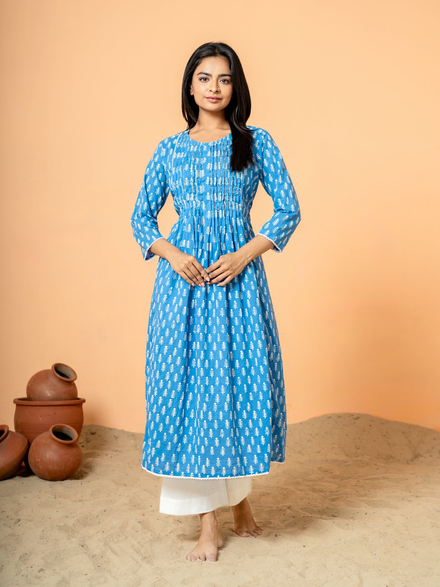 Full front view of the elegant Blue Palm Leaf Printed Cotton Kurta, showcasing the beautiful blue hue, intricate leaf print design, classic round neck, and 3/4th sleeves on soft, pure cotton fabric.