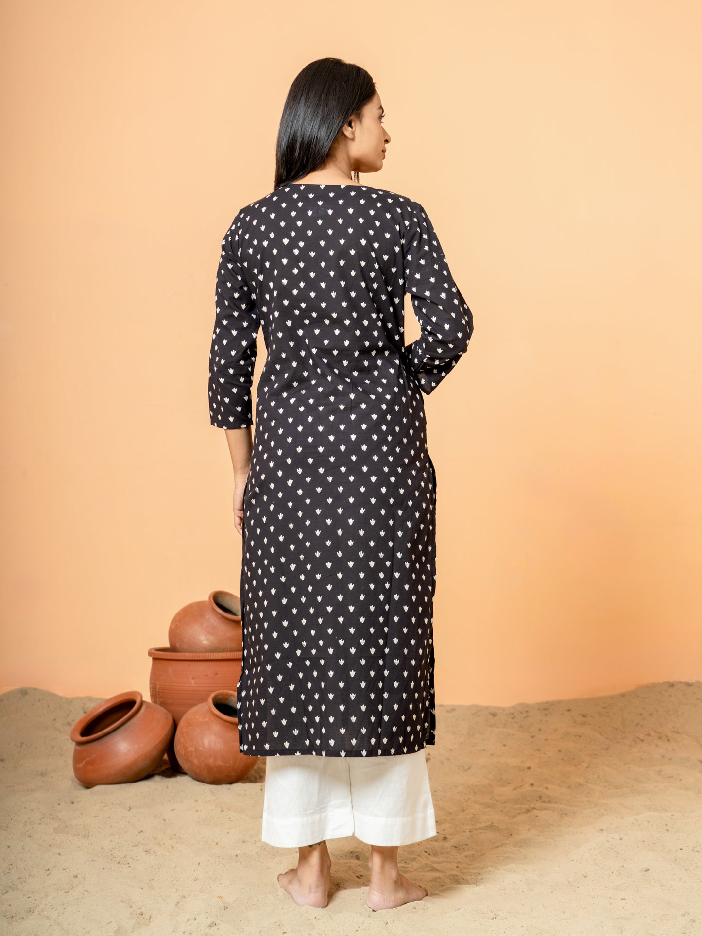 Back view of the elegant black cotton kurta with subtle embroidery details.