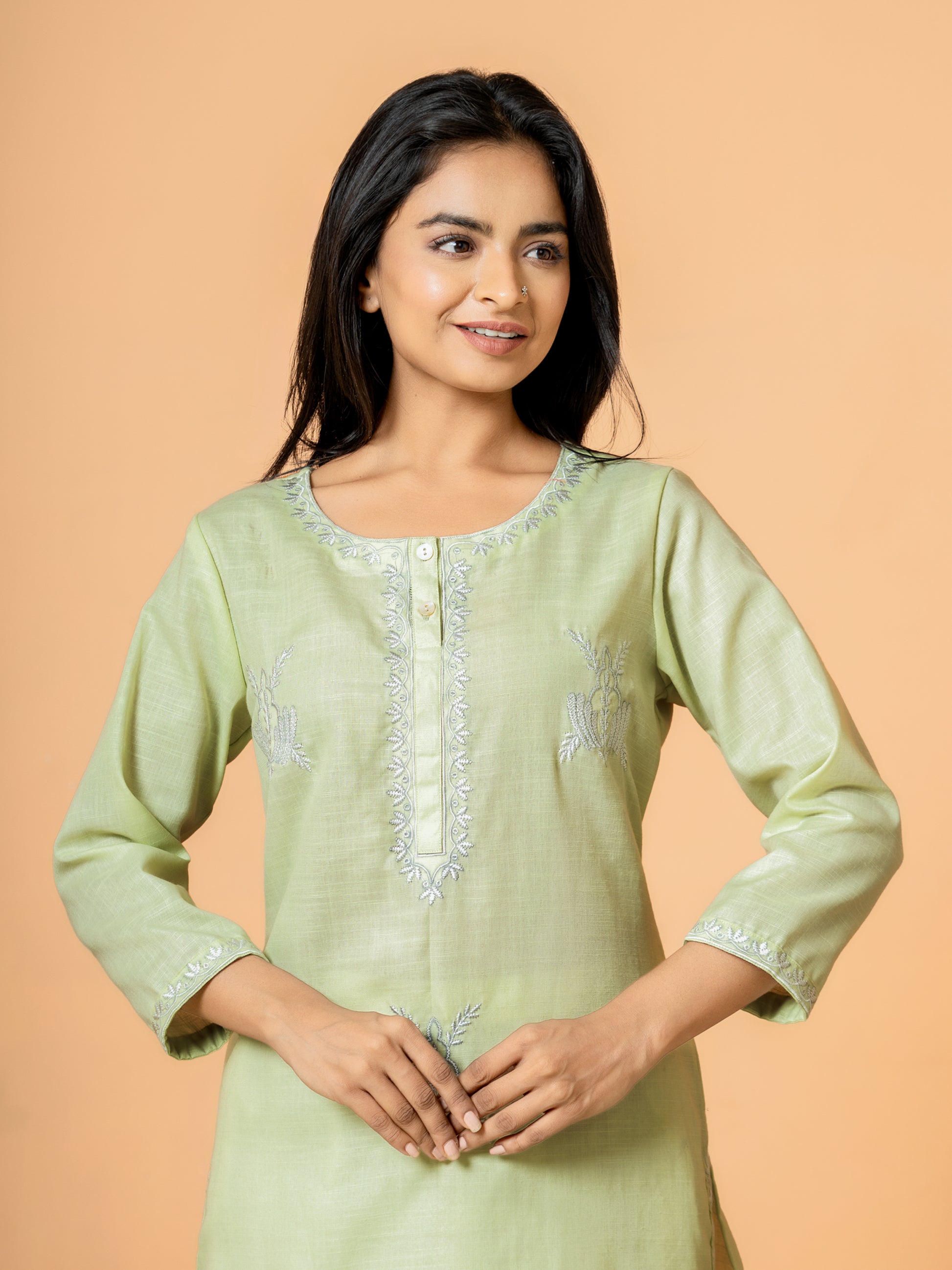 Close-up of the classic round neck design on the Pretty Pista Embroidered Straight Cotton Kurta, adding a sophisticated look to this elegant women's kurta.