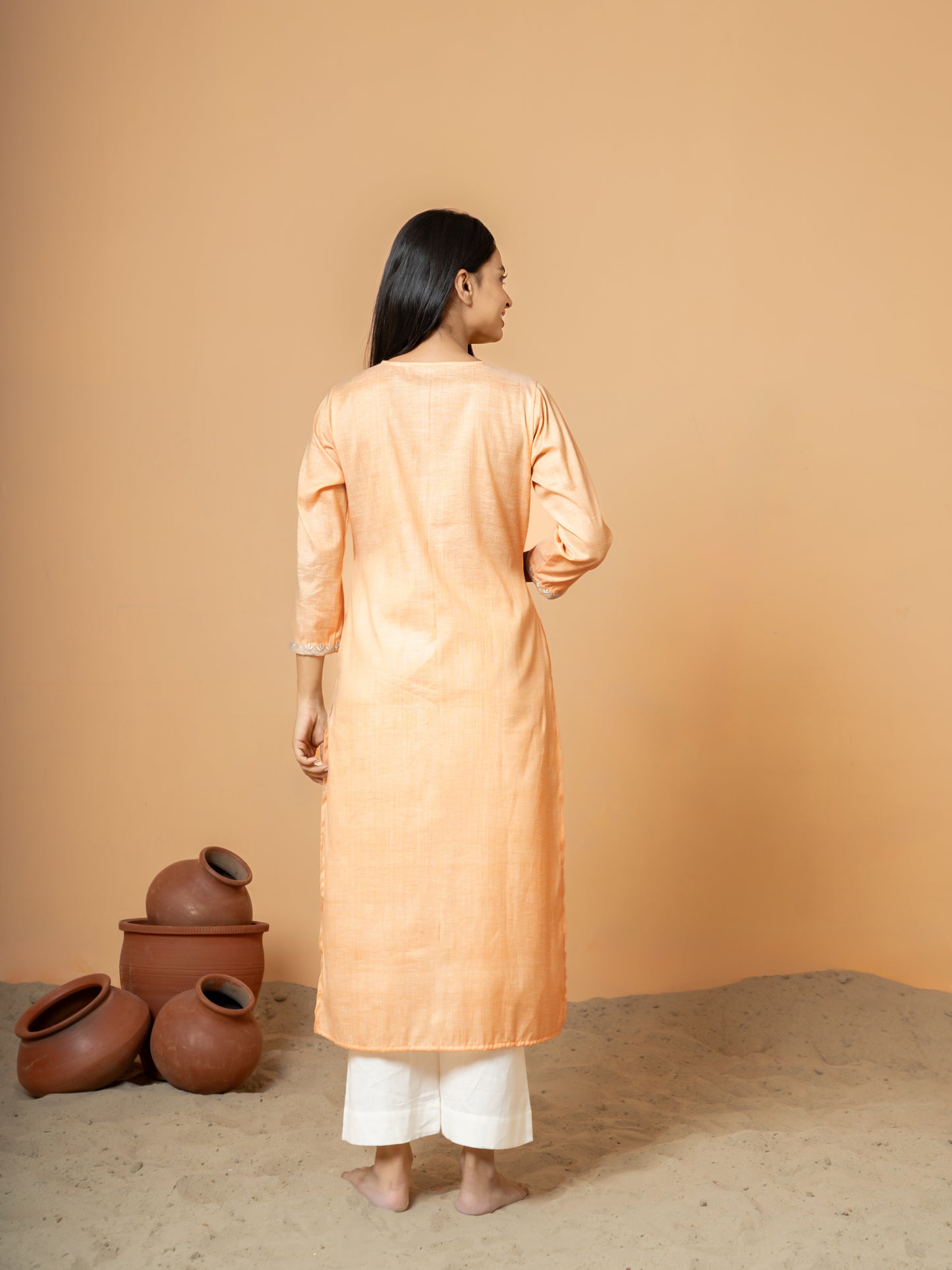 Back view of the Pastel Orange Embroidered Straight Cotton Kurta, showcasing its elegant embroidery and straight fit design, ideal for festive occasions and party wear.