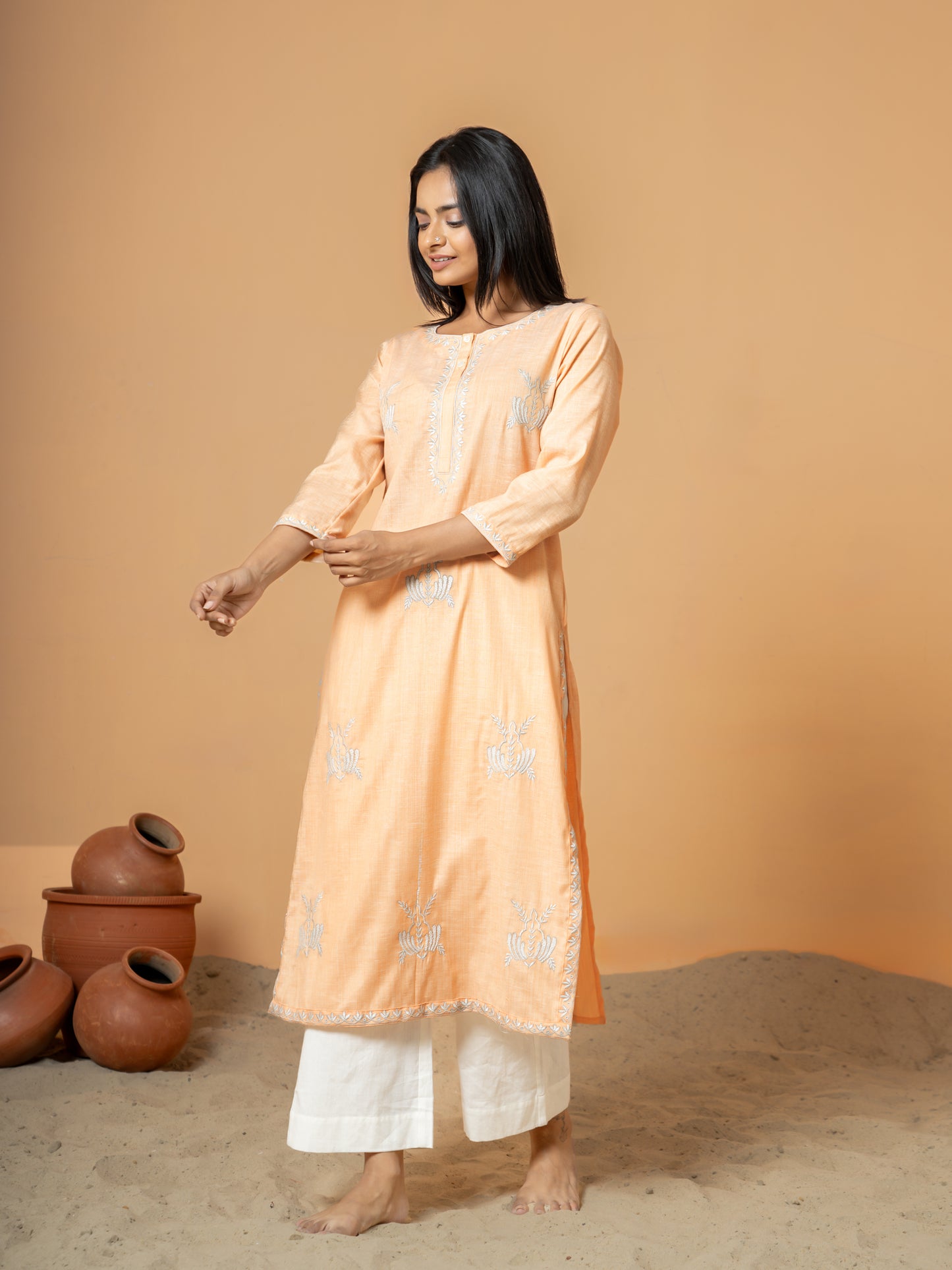 Stylish shot of the Pastel Orange Embroidered Straight Cotton Kurta, highlighting the comfortable Regular Fit and its suitability for casual outings and everyday wear.
