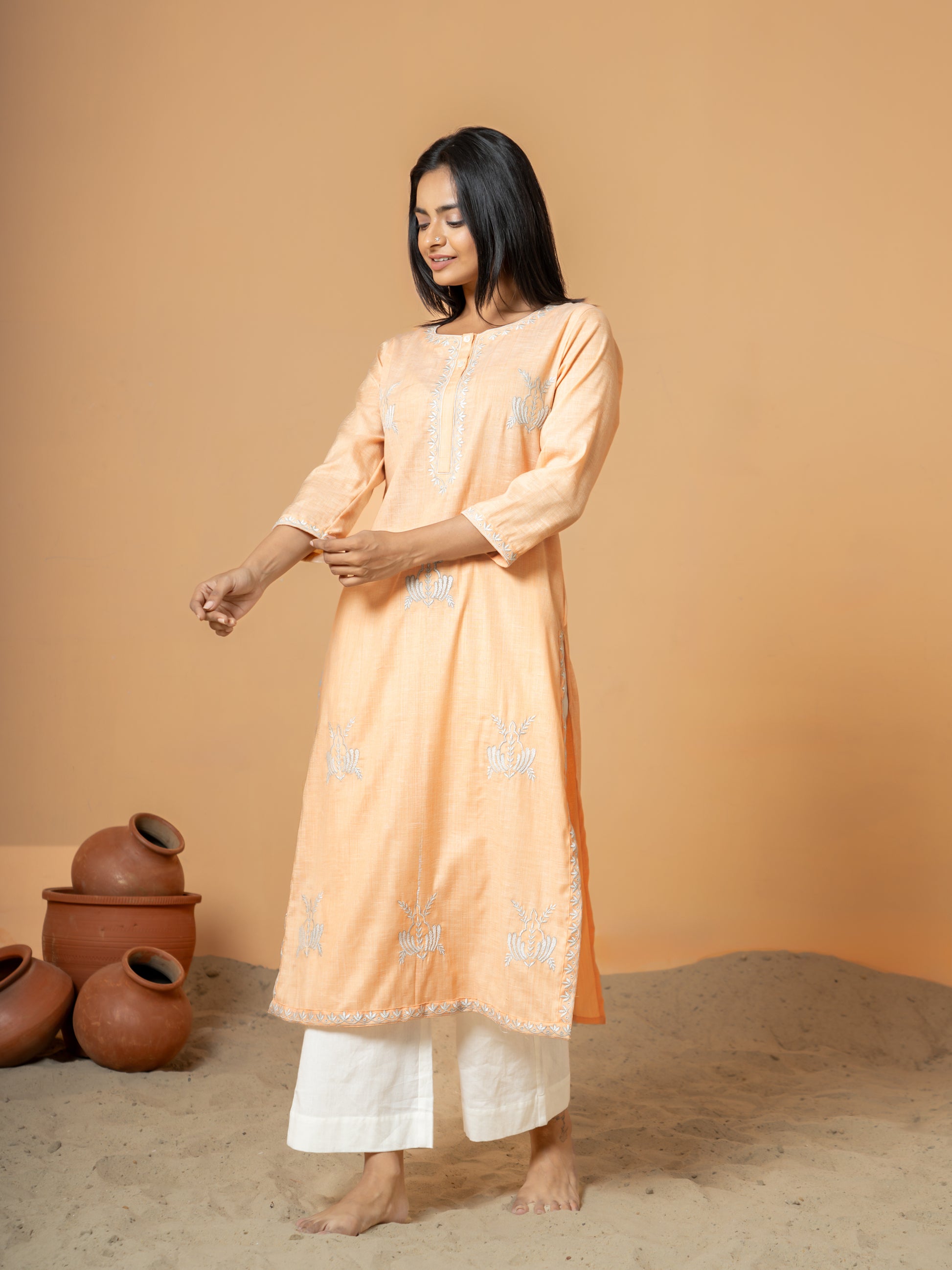 Stylish shot of the Pastel Orange Embroidered Straight Cotton Kurta, highlighting the comfortable Regular Fit and its suitability for casual outings and everyday wear.