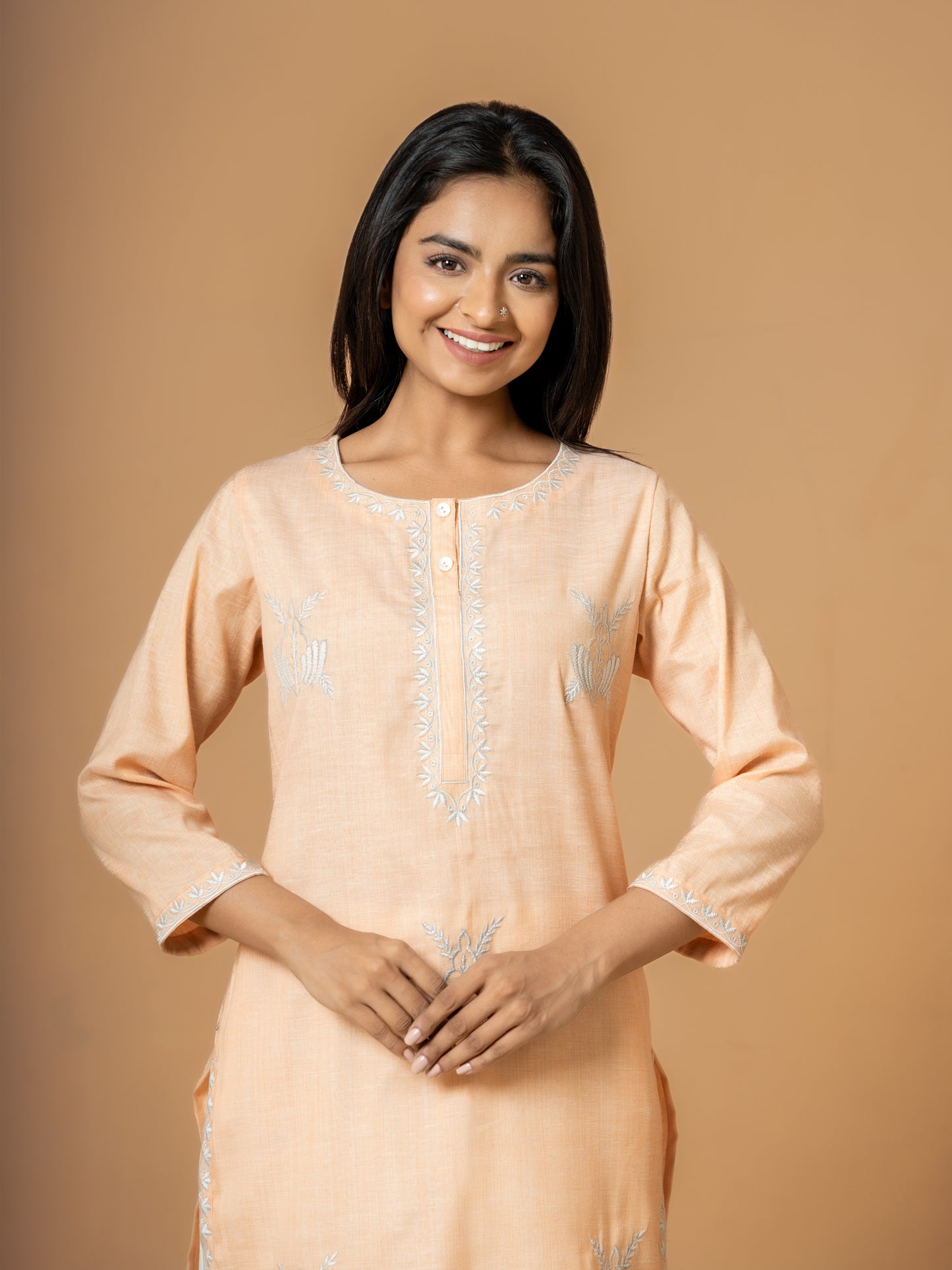 Detailed view of the classic round neck design on the elegant Pastel Orange Cotton Kurta, perfect for casual or festive occasions.