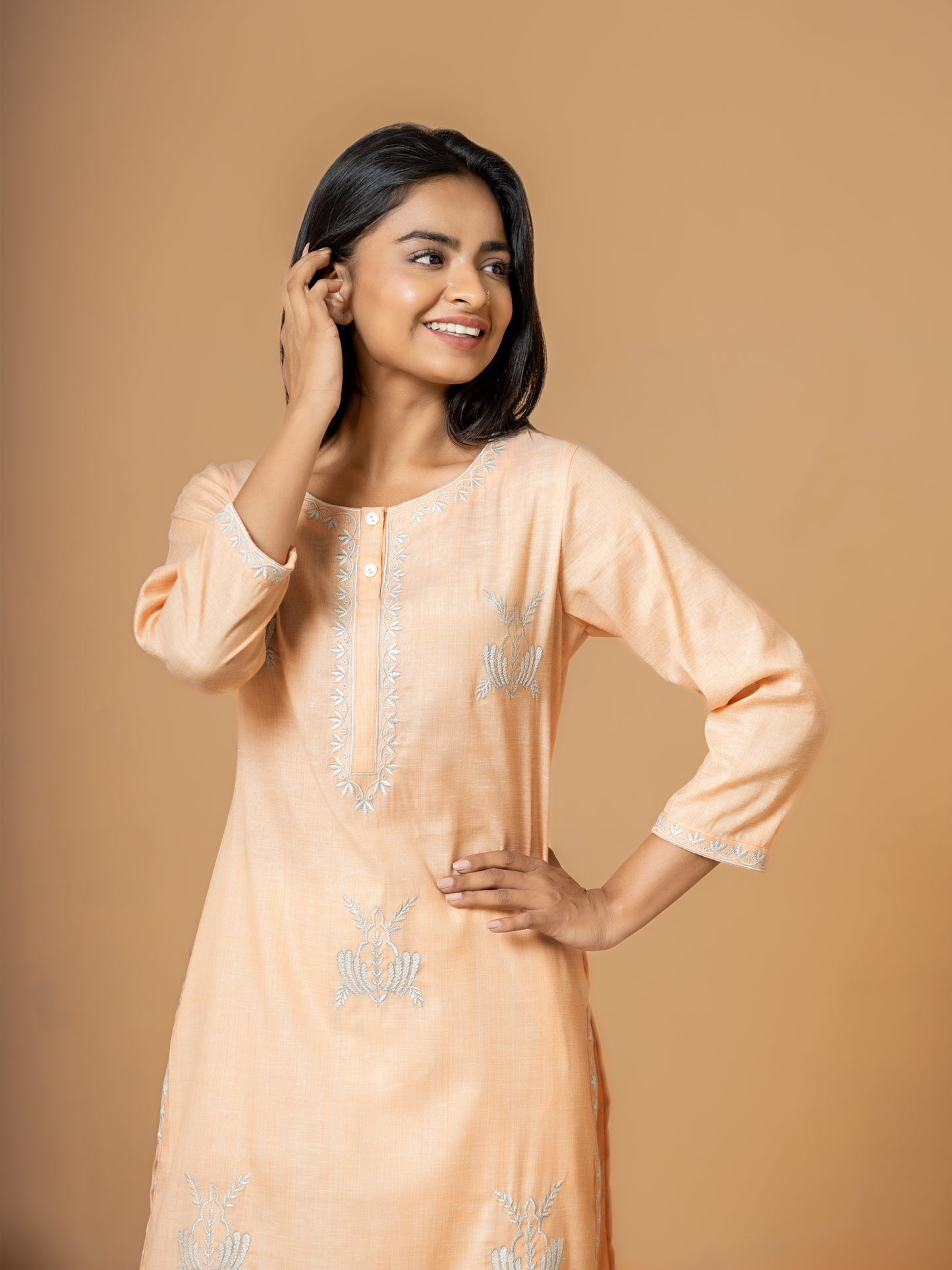 Image showing the versatile 3/4th sleeves of the comfortable Pastel Orange Embroidered Cotton Kurta, suitable for all seasons.
