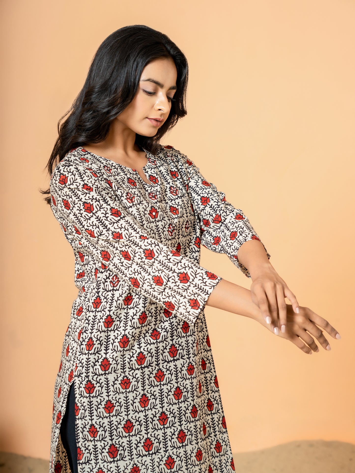 View showing the comfortable regular fit and 3/4th sleeves of the Cream Lotus Print Cotton Kurta