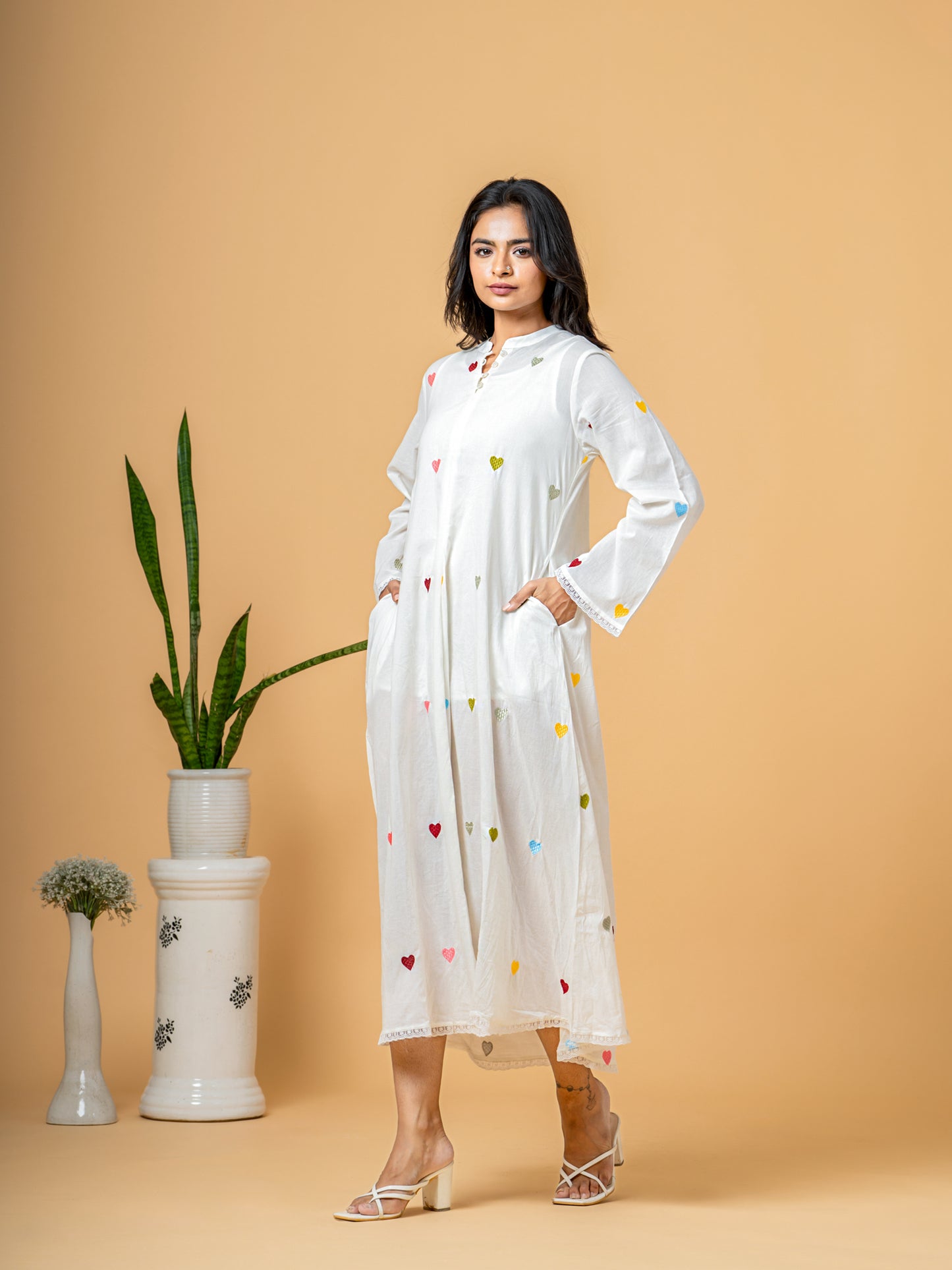 Side profile of the Rich White Good Heart Cotton Kurta from Cottons Daily, illustrating the elegant silhouette and continuous heart print on pure cotton fabric.