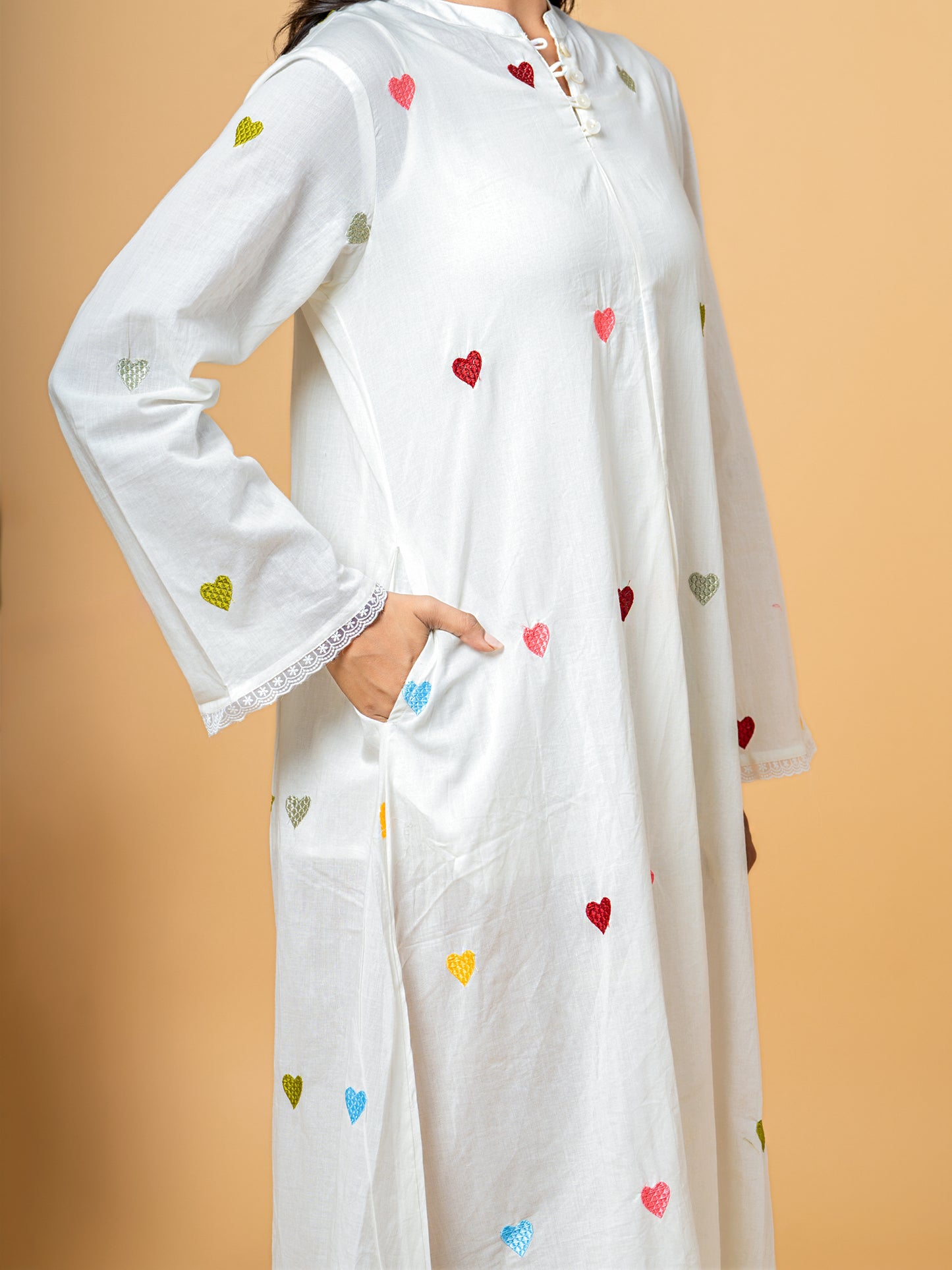 Side profile of the Rich White Good Heart Cotton Kurta from Cottons Daily, illustrating the elegant silhouette and continuous heart print on pure cotton fabric.