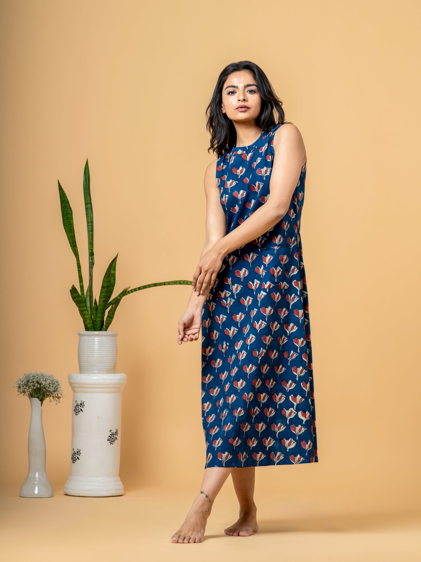 View of the hemline of the Stylish Indigo Floral A-line Cotton Kurta, showcasing the finishing detail of the floral print.