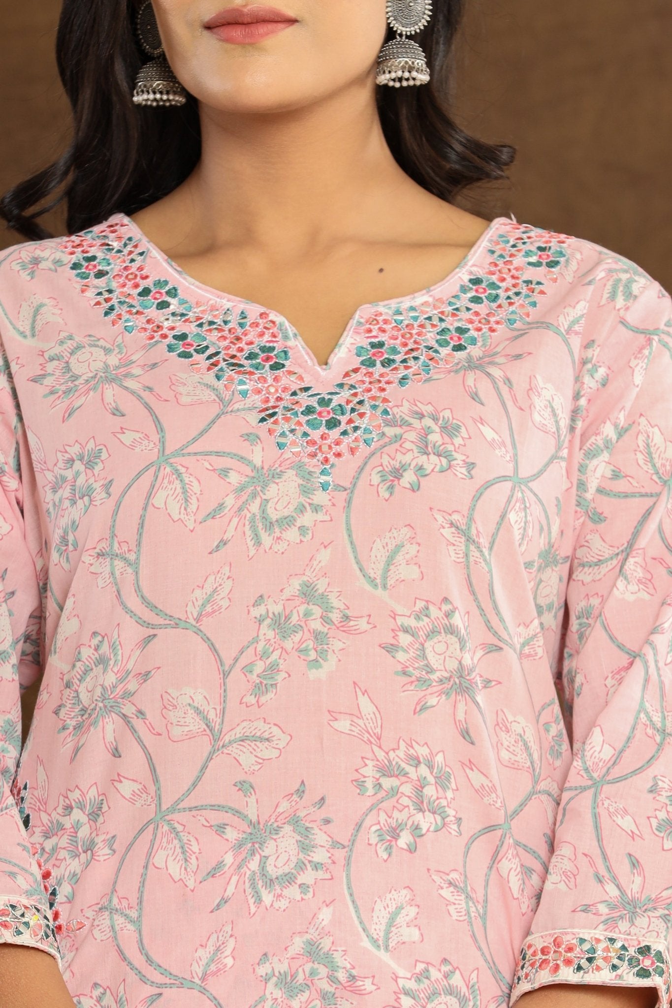 Embroidery Close-Up: Close-up shot of the intricate embroidery and gotta patti foil work on the Baby Pink Lotus Printed Afghani Cotton Suit's neckline.
