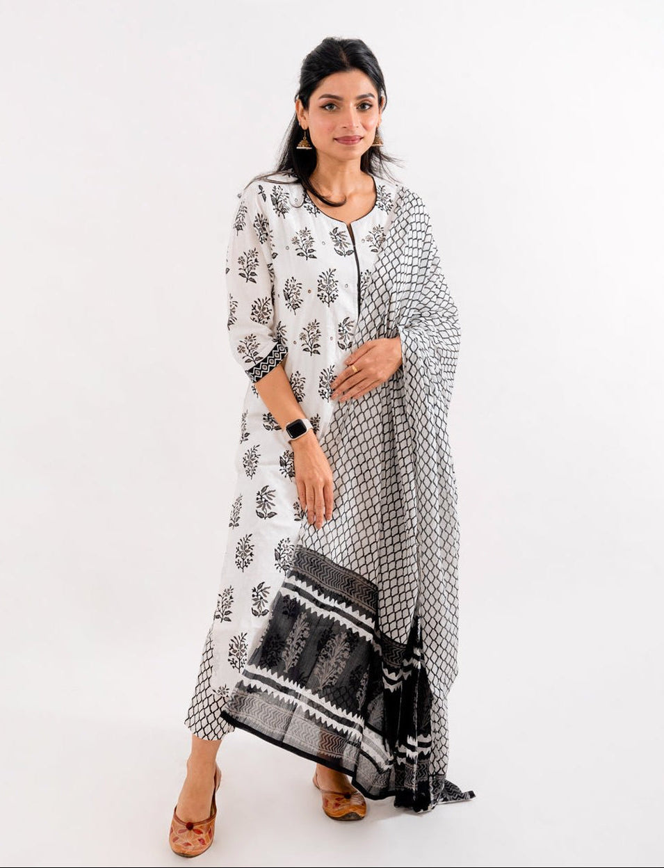Front view of the Black & White Printed Cotton Suit from Cottons Daily, featuring a round-neck kurta with delicate mirror work and 3/4th sleeves.