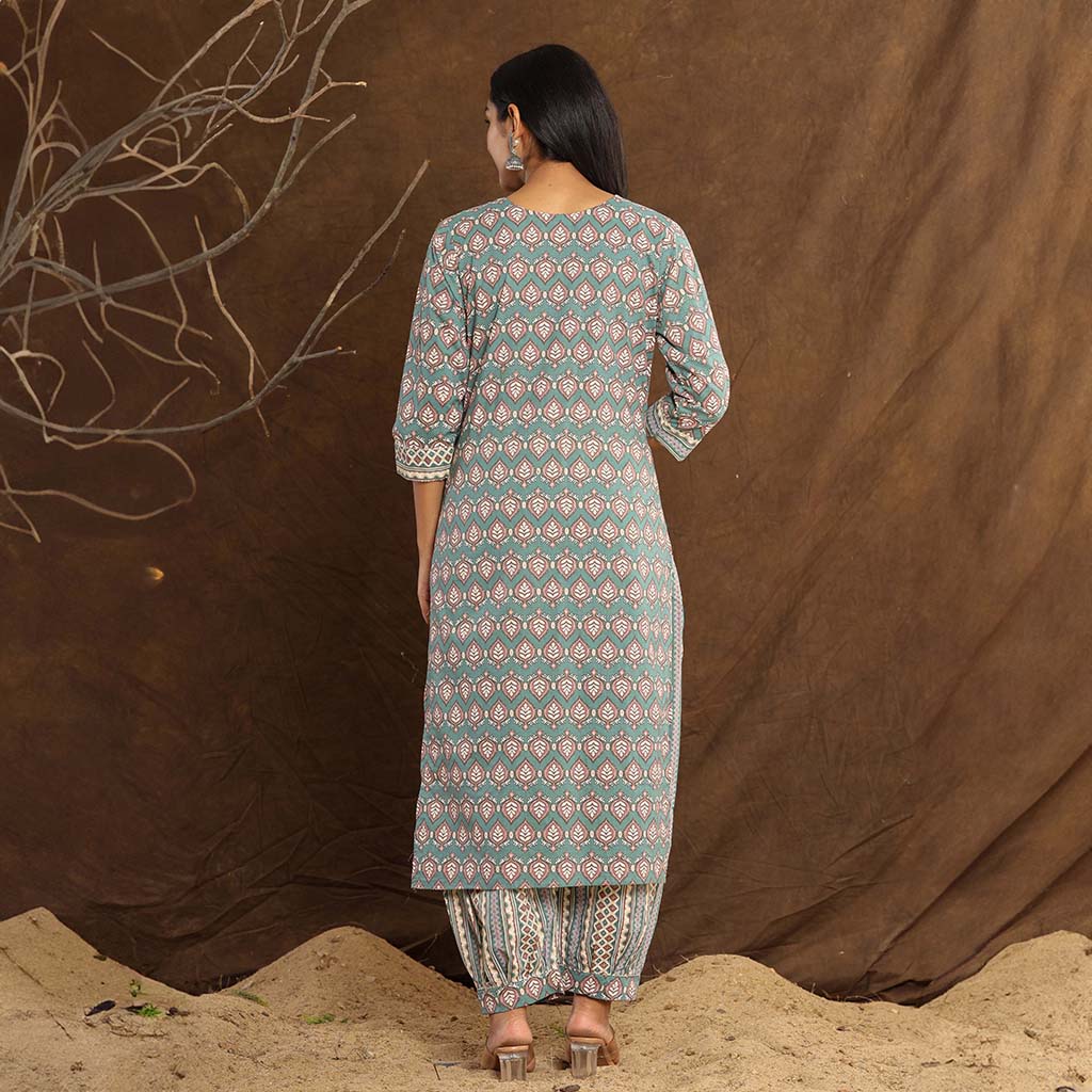 Back view of the  Off White Floral Cotton Embroidered Suit by Cottons Daily wore by a model showcasing the back designs and perfectly combined afgani style pants.