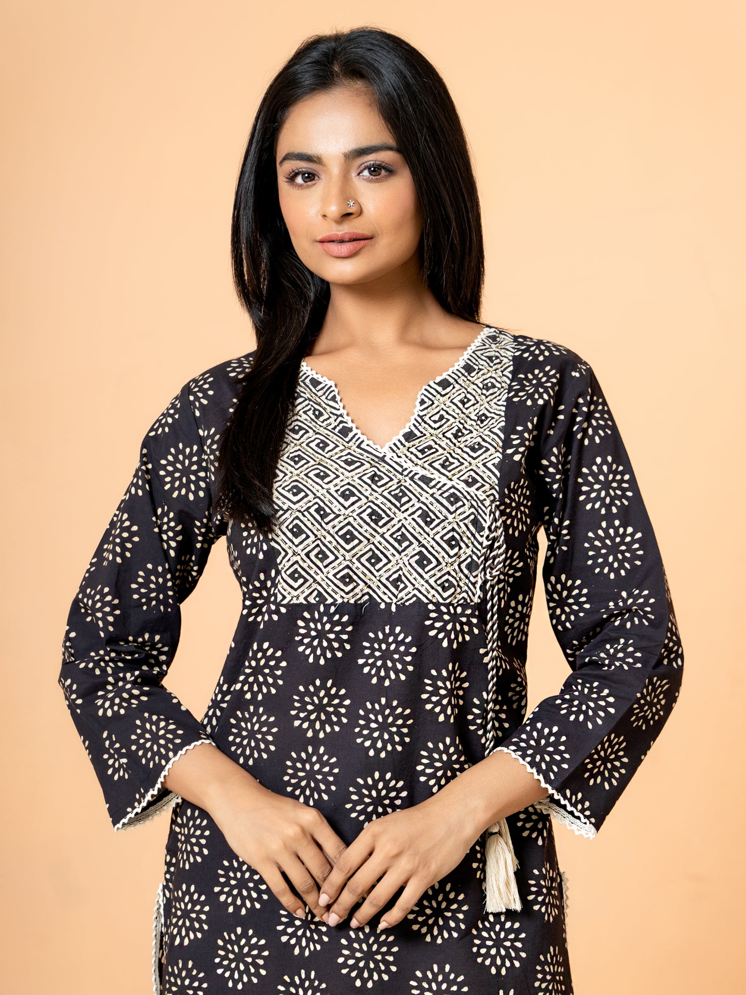 Close-up detail of the vibrant Black cotton fabric showing the intricate rangoli print design on the kurta.